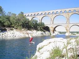Cliff jumping under the historic arches of the Pont du Gard, by Ben Platts (2005)