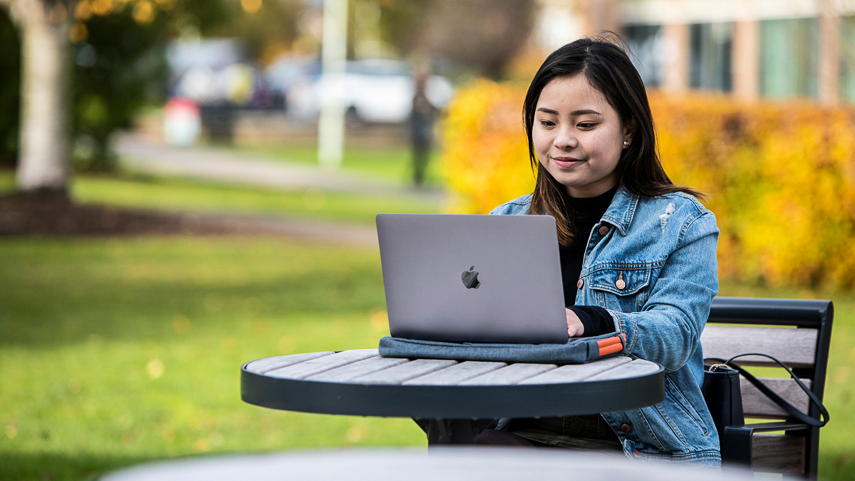 Student using a laptop outdoors