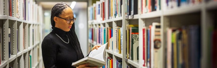 Student browsing books in the Library